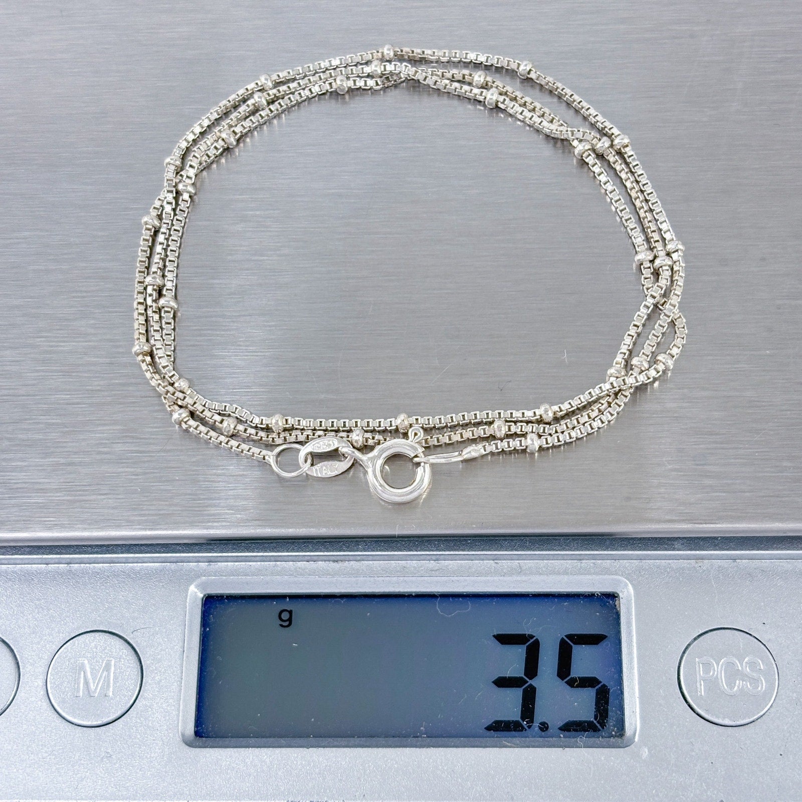 Silver box chain necklace on a digital scale displaying a weight of 3.5 grams.