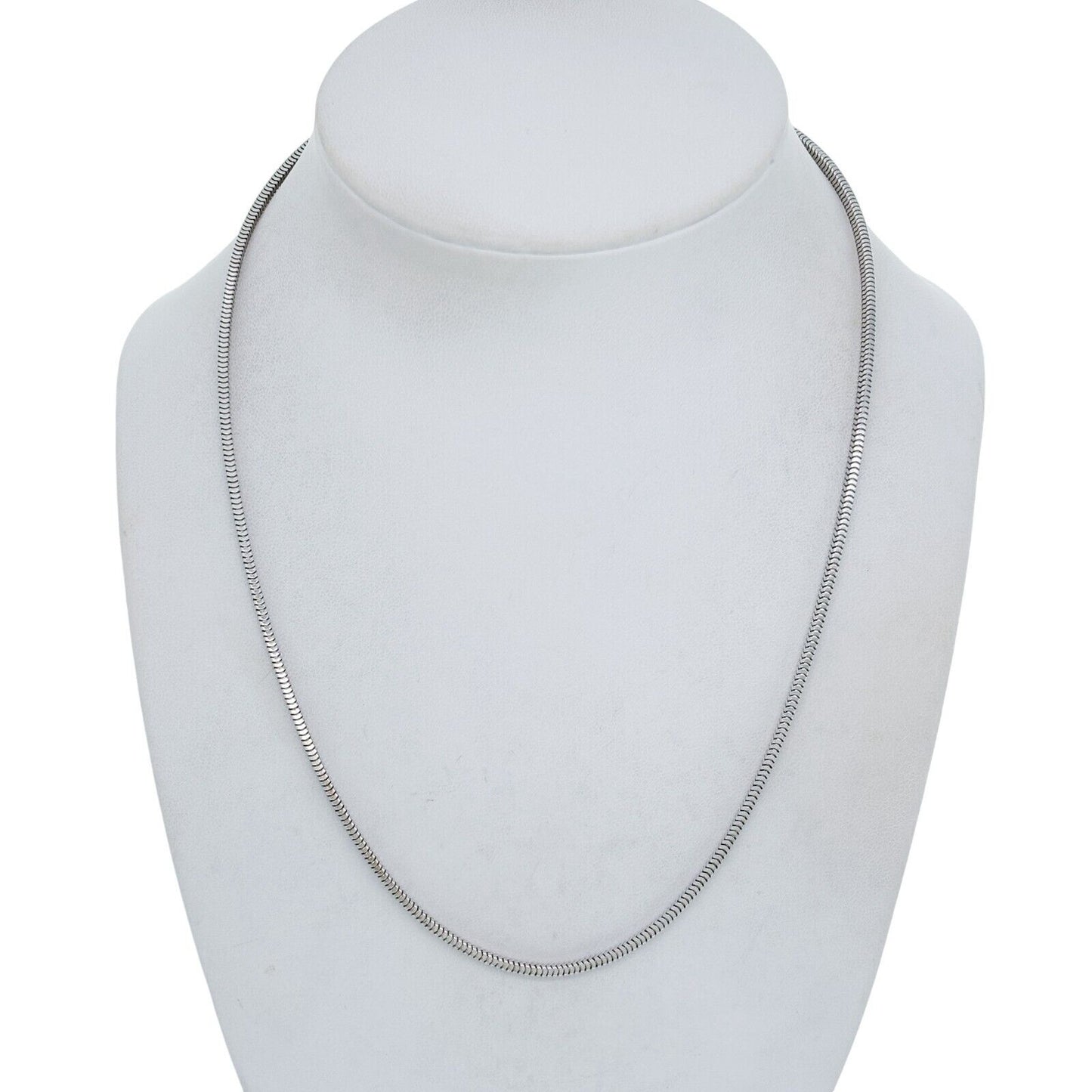 Silver snake chain necklace on a white mannequin bust