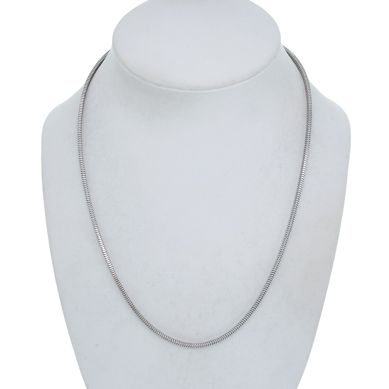 Silver snake chain necklace on a white mannequin bust