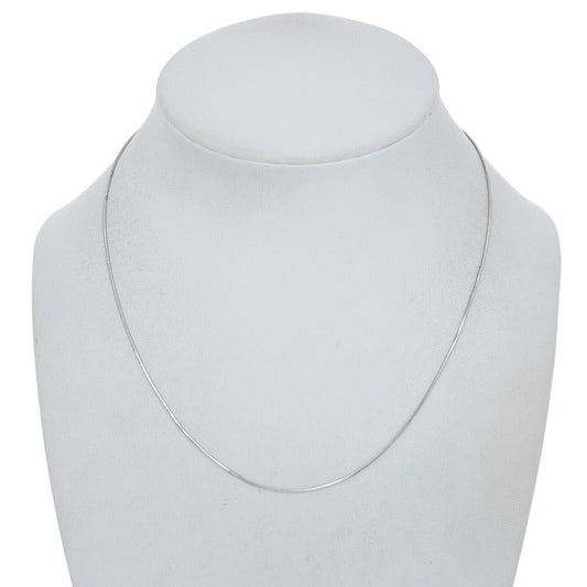 Silver necklace on a mannequin bust against a white background