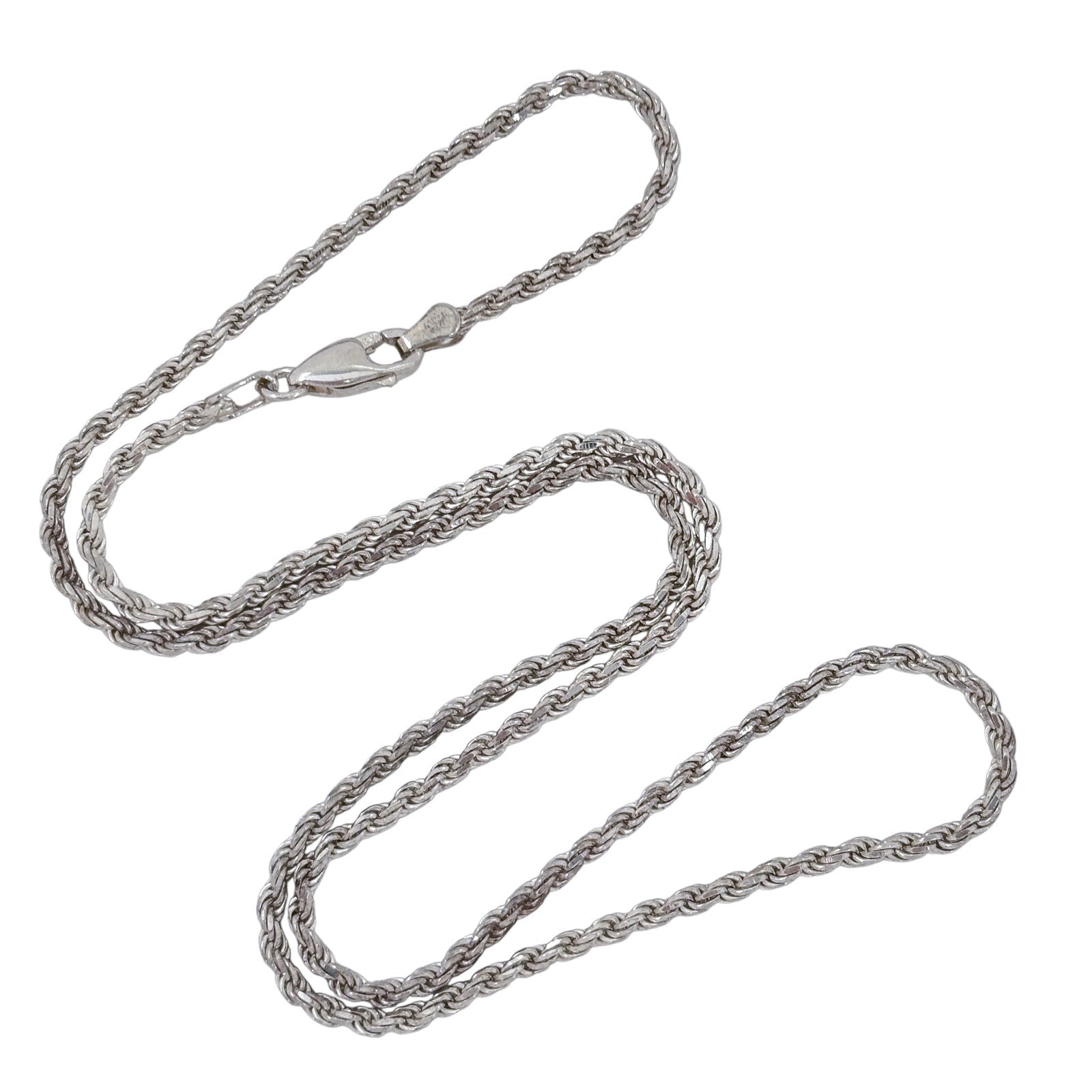 Silver rope chain necklace on a white background