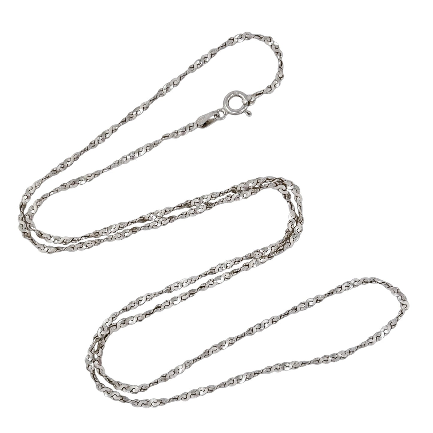 Silver serpentine chain necklace on a white background