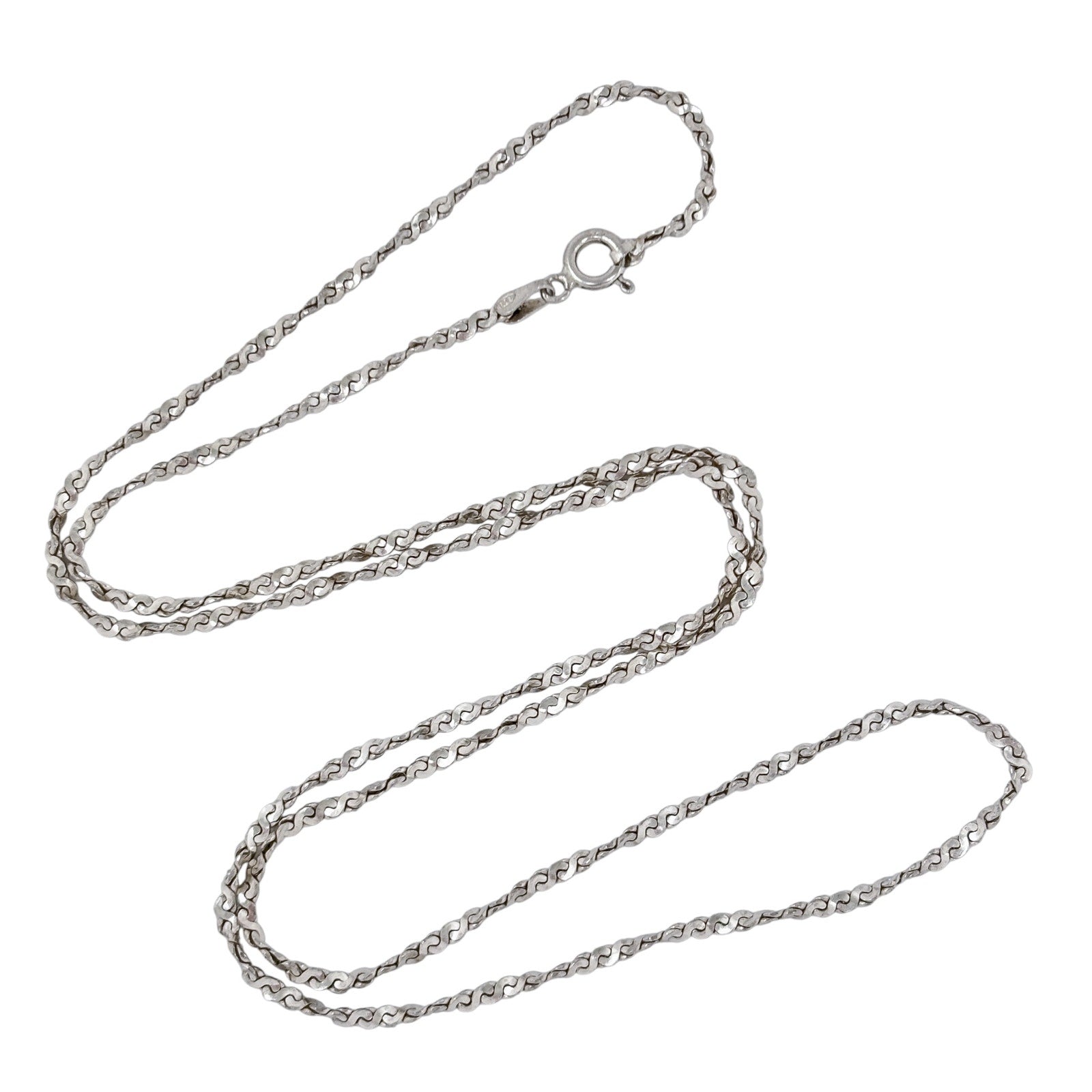 Silver serpentine chain necklace on a white background