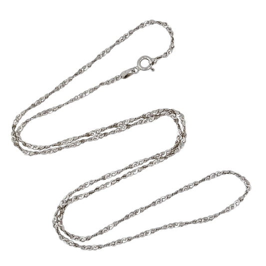 Silver serpentine chain necklace on a white background