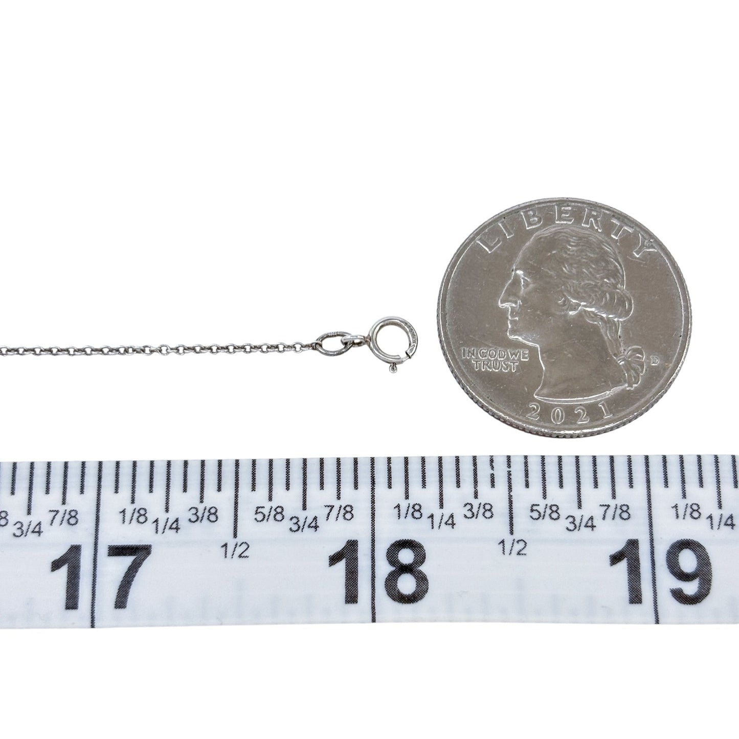 Silver necklace with a coin charm on a white background