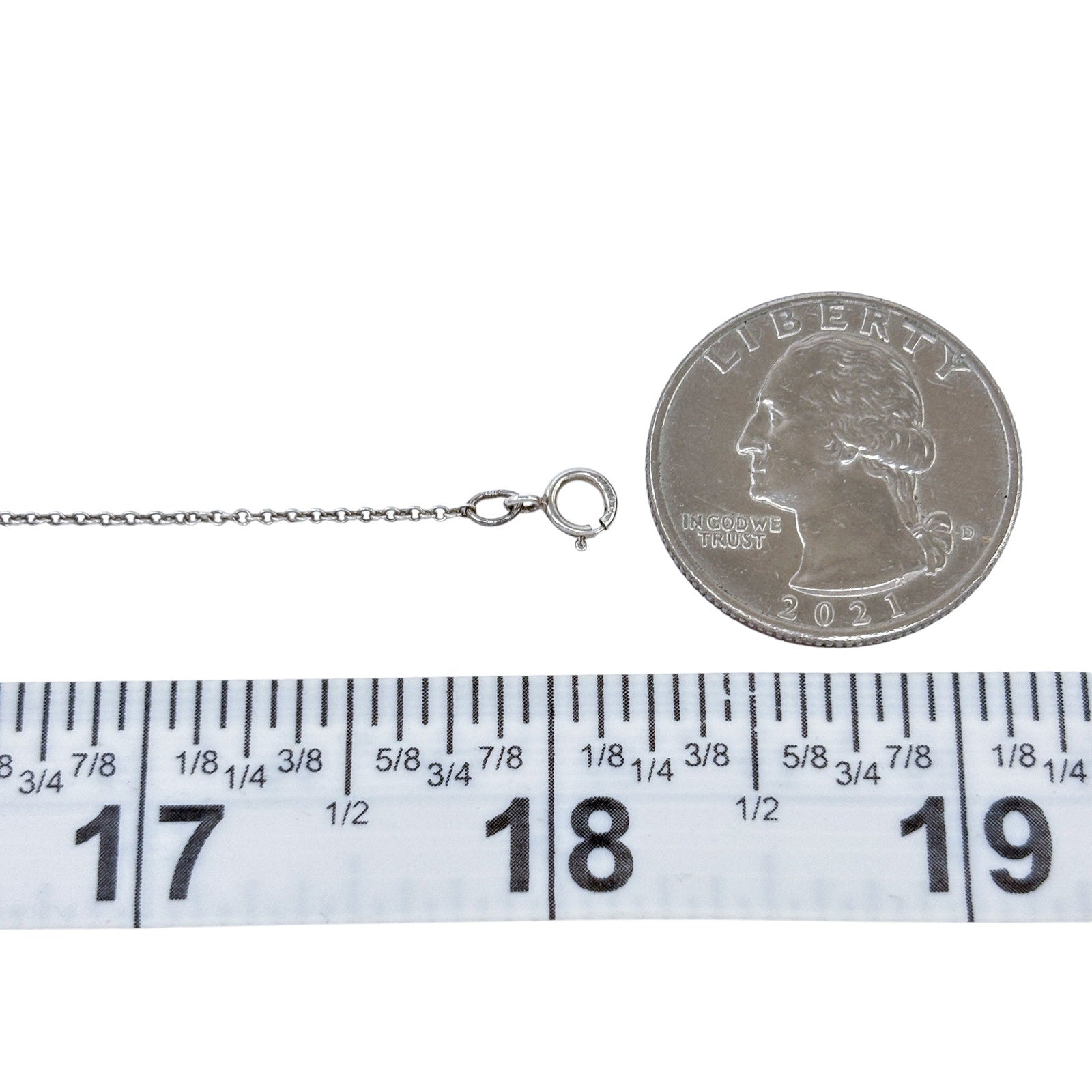 Silver necklace with a coin charm on a white background