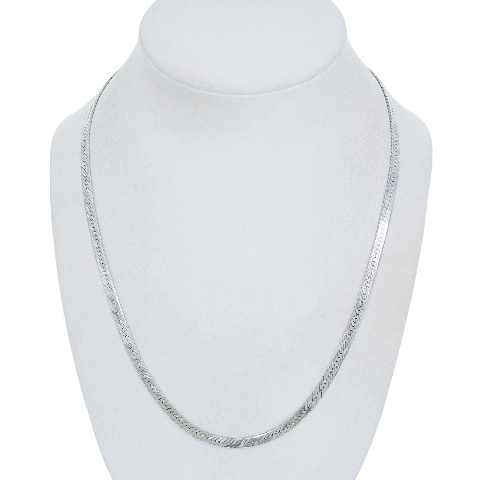 Silver herringbone chain necklace on a white mannequin bust