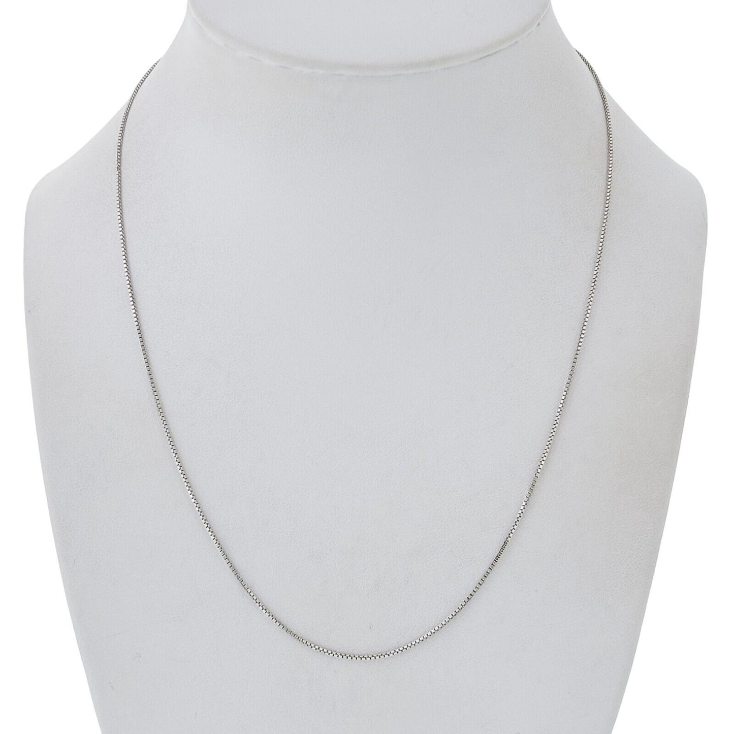 Silver box chain necklace on a mannequin bust against a white background