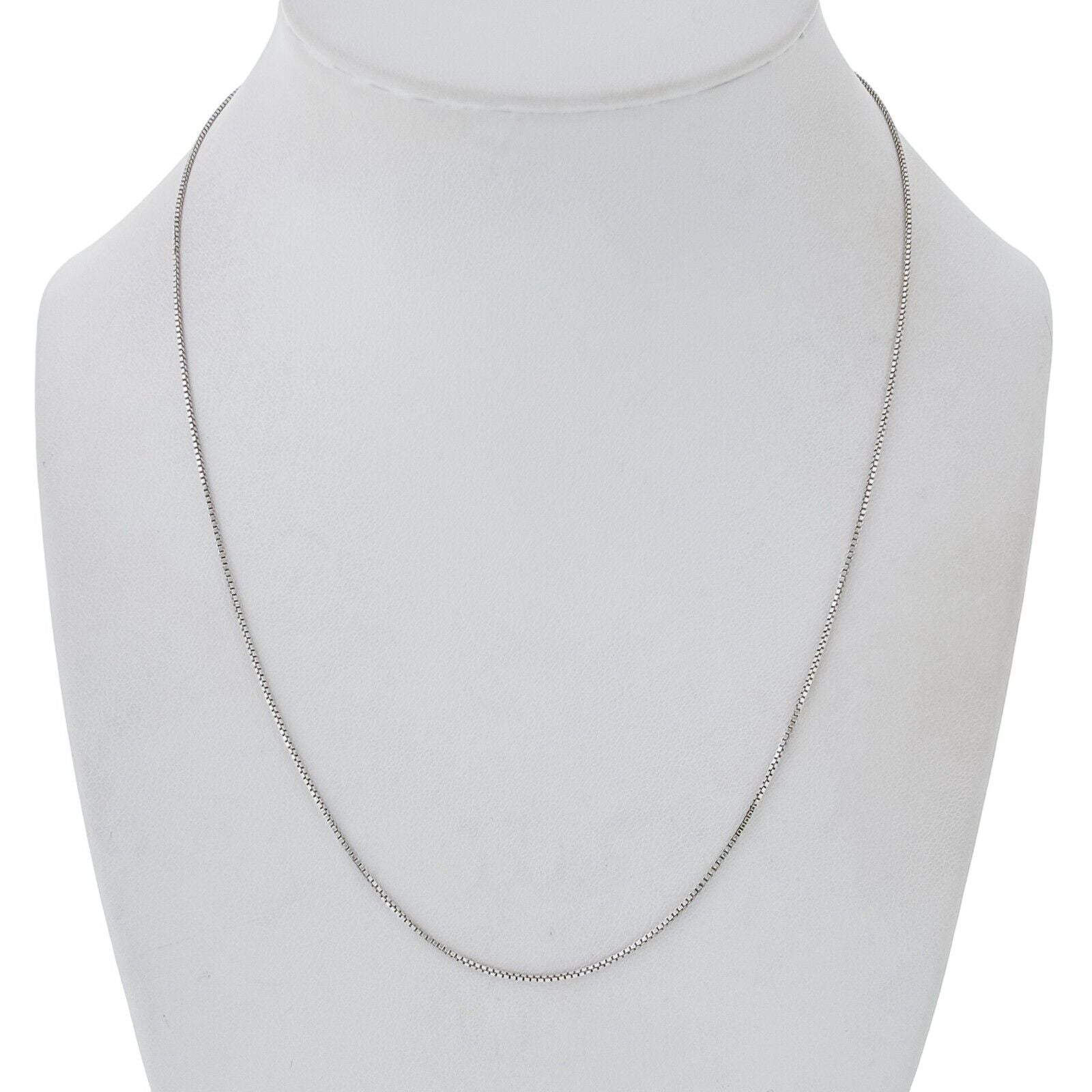 Silver box chain necklace on a mannequin bust against a white background